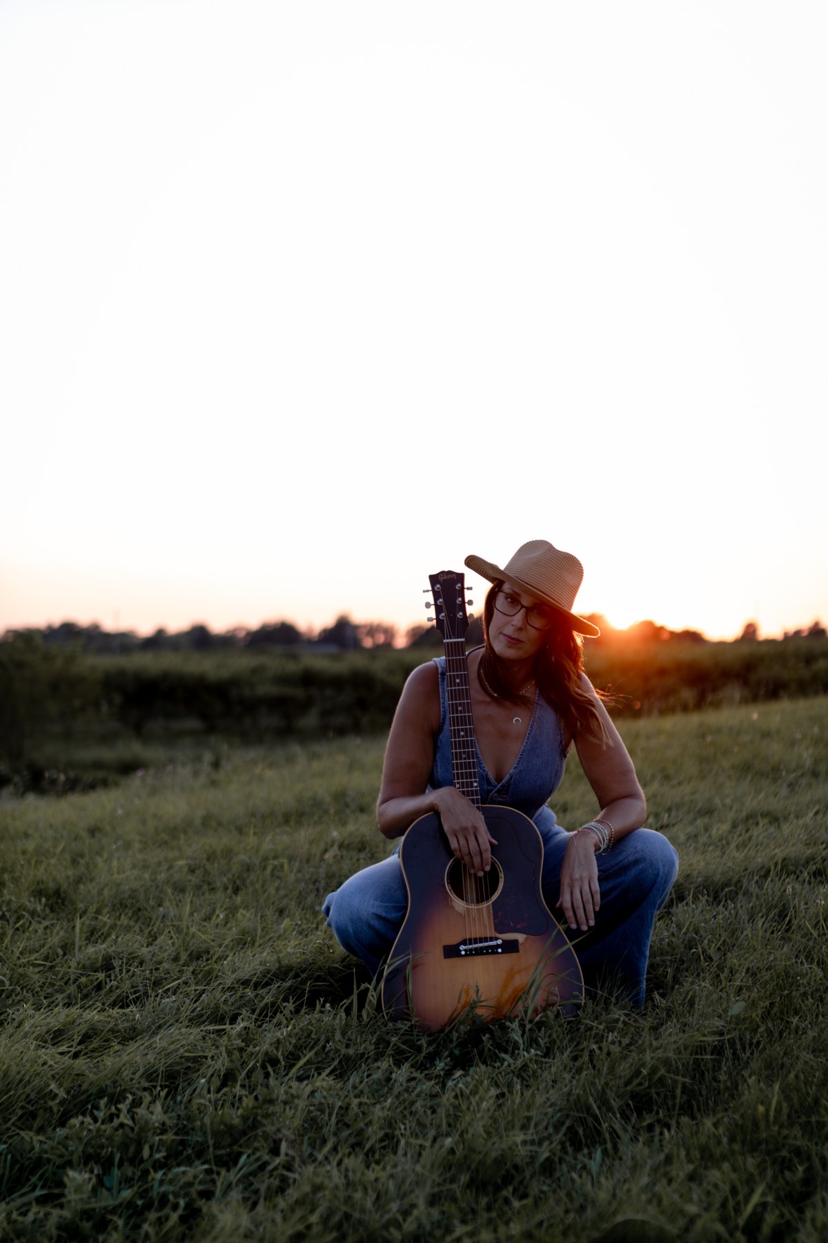 Michelle Hedley and her acoustic guitar at sunset